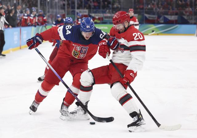 (260217) -- MILAN, Feb. 17, 2026 (Xinhua) -- David Kampf (L) of the Czech Republic vies with Lars Eller of Denmark during the ice hockey men's qualification play-off match between the Czech Republic and Denmark at the Milan-Cortina 2026 Olympic Winter Games in Milan, Italy, Feb. 17, 2026. (Xinhua/Wang Kaiyan)