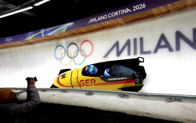 (260218) -- CORTINA D'AMPEZZO, Feb. 18, 2026 (Xinhua) -- Adam Ammour (L)/Alexander Schaller of Germany compete during the Bobsleigh 2-man heat 3 at the Milan-Cortina 2026 Olympic Winter Games in Cortina D'Ampezzo, Italy, Feb. 17, 2026. (Xinhua/Ding Xu)