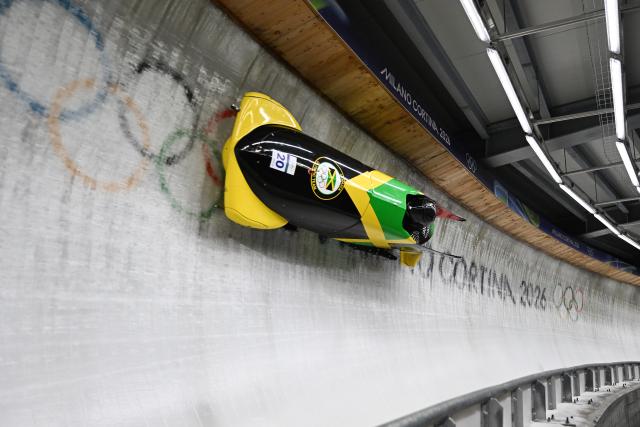 (260218) -- CORTINA D'AMPEZZO, Feb. 18, 2026 (Xinhua) -- Shane Pitter (L)/Junior Harris of Jamaica compete during the Bobsleigh 2-man heat 3 at the Milan-Cortina 2026 Olympic Winter Games in Cortina D'Ampezzo, Italy, Feb. 17, 2026. (Xinhua/Lian Yi)