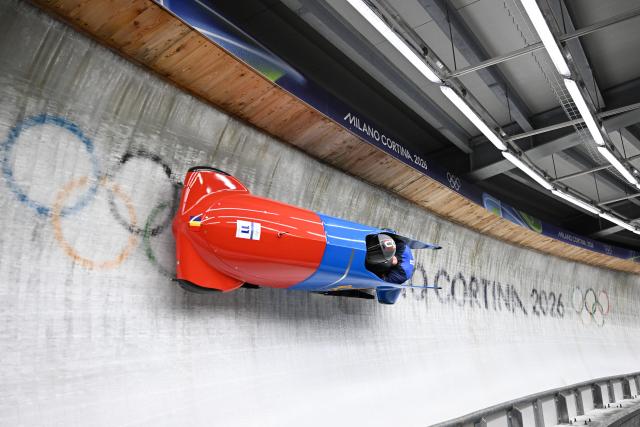 (260218) -- CORTINA D'AMPEZZO, Feb. 18, 2026 (Xinhua) -- Mihai Cristian Tentea (L)/George Iordache of Romania compete during the Bobsleigh 2-man heat 3 at the Milan-Cortina 2026 Olympic Winter Games in Cortina D'Ampezzo, Italy, Feb. 17, 2026. (Xinhua/Lian Yi)