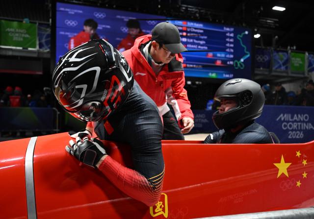 (260218) -- CORTINA D'AMPEZZO, Feb. 18, 2026 (Xinhua) -- Sun Kaizhi (L)/An Tai of China react after the Bobsleigh 2-man heat 4 at the Milan-Cortina 2026 Olympic Winter Games in Cortina D'Ampezzo, Italy, Feb. 17, 2026. (Xinhua/Lian Yi)