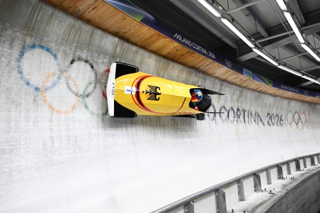 (260218) -- CORTINA D'AMPEZZO, Feb. 18, 2026 (Xinhua) -- Francesco Friedrich (L)/Alexander Schuller of Germany compete during the Bobsleigh 2-man heat 3 at the Milan-Cortina 2026 Olympic Winter Games in Cortina D'Ampezzo, Italy, Feb. 17, 2026. (Xinhua/Lian Yi)