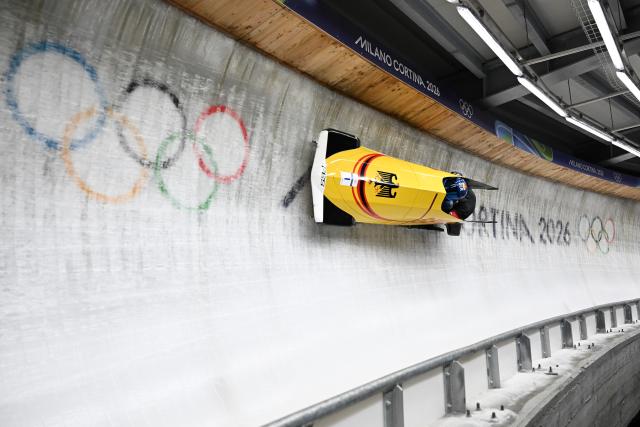 (260218) -- CORTINA D'AMPEZZO, Feb. 18, 2026 (Xinhua) -- Johannes Lochner (L)/Georg Fleischhauer of Germany compete during the Bobsleigh 2-man heat 3 at the Milan-Cortina 2026 Olympic Winter Games in Cortina D'Ampezzo, Italy, Feb. 17, 2026. (Xinhua/Lian Yi)