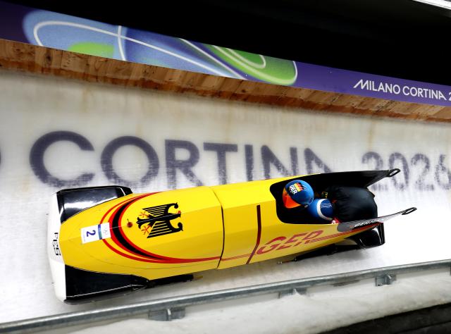(260218) -- CORTINA D'AMPEZZO, Feb. 18, 2026 (Xinhua) -- Francesco Friedrich (L)/Alexander Schuller of Germany compete during the Bobsleigh 2-man heat 3 at the Milan-Cortina 2026 Olympic Winter Games in Cortina D'Ampezzo, Italy, Feb. 17, 2026. (Xinhua/Ding Xu)