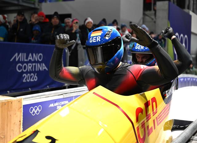 (260218) -- CORTINA D'AMPEZZO, Feb. 18, 2026 (Xinhua) -- Adam Ammour (L)/Alexander Schaller of Germany react during the Bobsleigh 2-man heat 4 at the Milan-Cortina 2026 Olympic Winter Games in Cortina D'Ampezzo, Italy, Feb. 17, 2026. (Xinhua/Lian Yi)