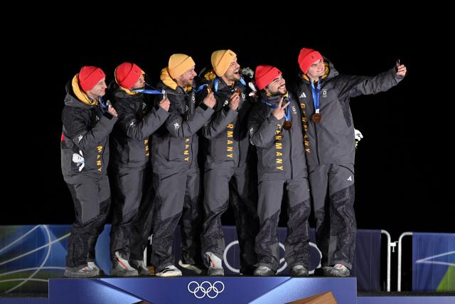 (260218) -- CORTINA D'AMPEZZO, Feb. 18, 2026 (Xinhua) -- Gold medalists Johannes Lochner (3rd L)/Georg Fleischhauer (3rd R), silver medalists Francesco Friedrich (1st L)/Alexander Schuller (2nd L) and bronze medalists Adam Ammour (2nd R)/Alexander Schaller of Germany take selfies during the awarding ceremony for the Bobsleigh 2-man at the Milan-Cortina 2026 Olympic Winter Games in Cortina D'Ampezzo, Italy, Feb. 17, 2026. (Xinhua/Lian Yi)