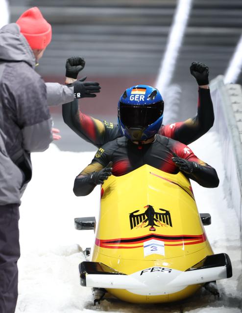 (260218) -- CORTINA D'AMPEZZO, Feb. 18, 2026 (Xinhua) -- Adam Ammour (front)/Alexander Schaller of Germany celebrate after the Bobsleigh 2-man heat 4 at the Milan-Cortina 2026 Olympic Winter Games in Cortina D'Ampezzo, Italy, Feb. 17, 2026. (Xinhua/Ding Xu)