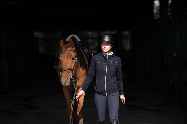 (260218) -- GUANGDE, Feb. 18, 2026 (Xinhua) -- Sasha leads a horse to attend a training at the Yangtze River Delta International Equestrian Center in Dongting Town of Guangde City, east China's Anhui Province, Jan. 15, 2026. Sasha, an equestrian from Russia, once studied in Shanghai and later went to Europe to study equestrian sports, where she met coach Vasil and eventually married him. They have a lovely daughter named Maya. In 2023, Sasha's family moved to Guangde to start a new life, as her husband Vasil was invited to teach at the Yangtze River Delta International Equestrian Center.
  "Riding has always been my favorite," Sasha said in Chinese. Sasha's family now lives near the equestrian center, where she trains daily in equestrian show jumping, takes walks with her beloved horse, and sometimes helps with horse training. Looking ahead, she hopes to participate in more equestrian competitions and to one day own her own ranch.
  Beyond the racetrack, Sasha engages in cultural activities to learn about local customs and traditions. Her daughter Maya attends a local kindergarten and has learned Chinese. Her husband Vasil's equestrian teaching is well received by students. These experiences have helped Sasha feel a sense of belonging in a place once unfamiliar to her. "Guangde is picturesque and has friendly people. Living and training here makes me feel wonderful," said Sasha. (Xinhua/Zhang Duan)