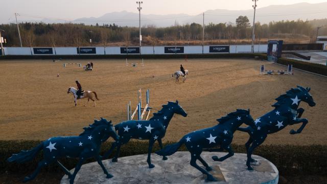 (260218) -- GUANGDE, Feb. 18, 2026 (Xinhua) -- An aerial drone photo taken on Jan. 16, 2026 shows a view of the Yangtze River Delta International Equestrian Center in Dongting Town of Guangde City, east China's Anhui Province. Sasha, an equestrian from Russia, once studied in Shanghai and later went to Europe to study equestrian sports, where she met coach Vasil and eventually married him. They have a lovely daughter named Maya. In 2023, Sasha's family moved to Guangde to start a new life, as her husband Vasil was invited to teach at the Yangtze River Delta International Equestrian Center.
  "Riding has always been my favorite," Sasha said in Chinese. Sasha's family now lives near the equestrian center, where she trains daily in equestrian show jumping, takes walks with her beloved horse, and sometimes helps with horse training. Looking ahead, she hopes to participate in more equestrian competitions and to one day own her own ranch.
  Beyond the racetrack, Sasha engages in cultural activities to learn about local customs and traditions. Her daughter Maya attends a local kindergarten and has learned Chinese. Her husband Vasil's equestrian teaching is well received by students. These experiences have helped Sasha feel a sense of belonging in a place once unfamiliar to her. "Guangde is picturesque and has friendly people. Living and training here makes me feel wonderful," said Sasha. (Xinhua/Zhang Duan)