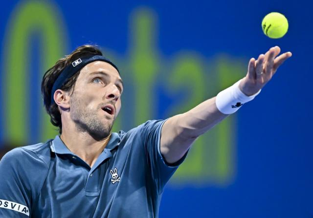 (260218) -- DOHA, Feb. 18, 2026 (Xinhua) -- Arthur Rinderknech of France serves during the men's singles round of 32 match against Carlos Alcaraz of Spain at the ATP Qatar Open 2026 tennis tournament in Doha, Qatar, on Feb. 17, 2026. (Photo by Nikku/Xinhua)