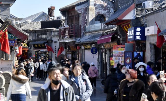 (260218) -- BEIJING, Feb. 18, 2026 (Xinhua) -- People visit the Yandaixiejie street in Beijing, capital of China, Feb. 18, 2026. People visit cultural scenic areas in Beijing to feel the festive atmosphere of the Spring Festival. (Xinhua/Li Xin)