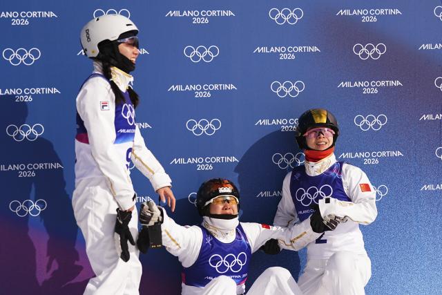 (260218) -- LIVIGNO, Feb. 18, 2026 (Xinhua) -- Shao Qi, Xu Mengtao and Kong Fanyu (L-R) of China react after the freestyle skiing women's aerials final 2 at the Milan-Cortina 2026 Olympic Winter Games in Livigno, Italy, Feb. 18, 2026. (Xinhua/Wu Huiwo)