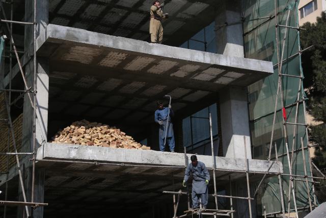 (260218) -- KABUL, Feb. 18, 2026 (Xinhua) -- Afghan workers work at the construction site of a housing project in Kabul, Afghanistan, Feb. 18, 2026. TO GO WITH "Feature: Afghan refugees return home to build lives, cities" (Photo by Saifurahman Safi/Xinhua)
