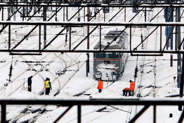 (260218) -- BUCHAREST, Feb. 18, 2026 (Xinhua) -- Workers clean snow at North Railway station in Bucharest, Romania, on Feb. 18, 2026. A heavy snowstorm hit southern and southeastern Romania overnight, prompting a red alert in Bucharest and disrupting road, air and maritime traffic, authorities said on Wednesday. (Photo by Cristian Cristel/Xinhua)