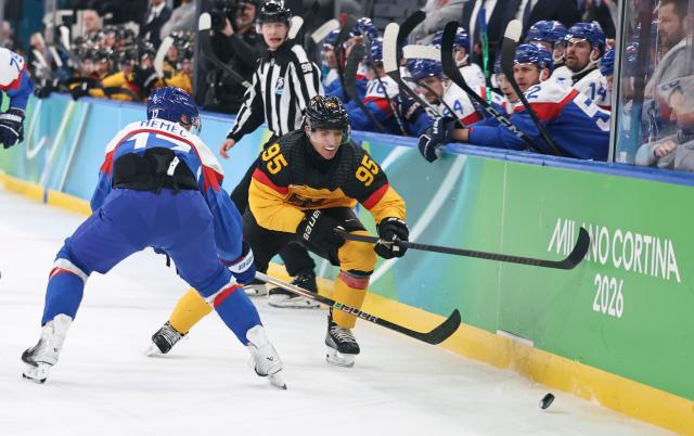 (260218) -- MILAN, Feb. 18, 2026 (Xinhua) -- Frederik Tiffels (R) of Germany vies with Simon Nemec of Slovakia during the ice hockey men's play-offs quarterfinal between the Slovakia and Germany at the Milan-Cortina 2026 Olympic Winter Games in Milan, Italy, Feb. 18, 2026. (Xinhua/Wang Kaiyan)