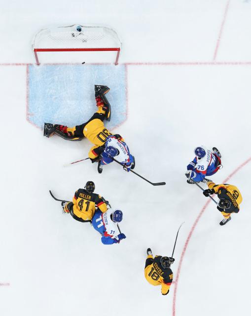 (260218) -- MILAN, Feb. 18, 2026 (Xinhua) -- Goalkeeper Philipp Grubauer (Top) of Germany fails to save the puck during the ice hockey men's play-offs quarterfinal between the Slovakia and Germany at the Milan-Cortina 2026 Olympic Winter Games in Milan, Italy, Feb. 18, 2026. (Xinhua/Wang Kaiyan)