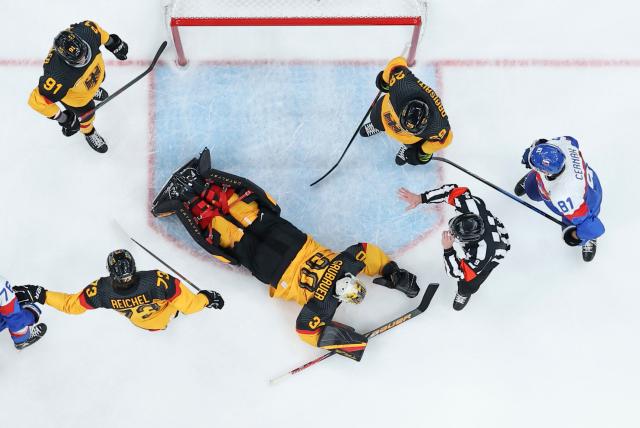 (260218) -- MILAN, Feb. 18, 2026 (Xinhua) -- Goalkeeper Philipp Grubauer (C) of Germany saves the puck during the ice hockey men's play-offs quarterfinal between the Slovakia and Germany at the Milan-Cortina 2026 Olympic Winter Games in Milan, Italy, Feb. 18, 2026. (Xinhua/Wang Kaiyan)