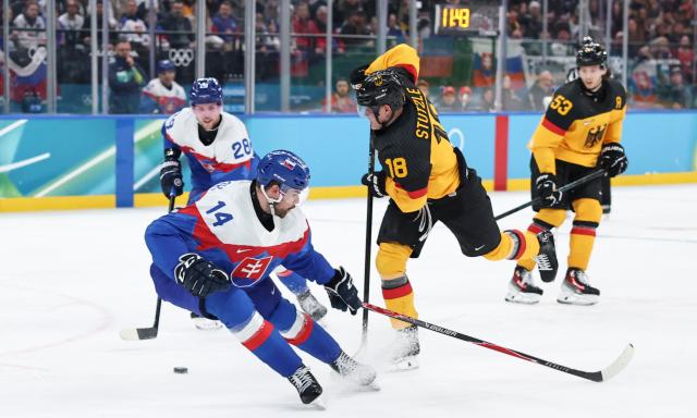 (260218) -- MILAN, Feb. 18, 2026 (Xinhua) -- Tim Stutzle (2nd R) of Germany breaks through during the ice hockey men's play-offs quarterfinal between the Slovakia and Germany at the Milan-Cortina 2026 Olympic Winter Games in Milan, Italy, Feb. 18, 2026. (Xinhua/Wang Kaiyan)