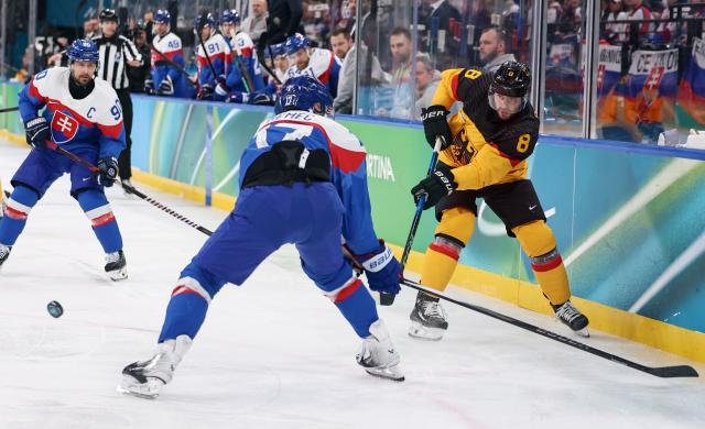 (260218) -- MILAN, Feb. 18, 2026 (Xinhua) -- Tobias Rieder (R) of Germany shoots during the ice hockey men's play-offs quarterfinal between the Slovakia and Germany at the Milan-Cortina 2026 Olympic Winter Games in Milan, Italy, Feb. 18, 2026. (Xinhua/Wang Kaiyan)