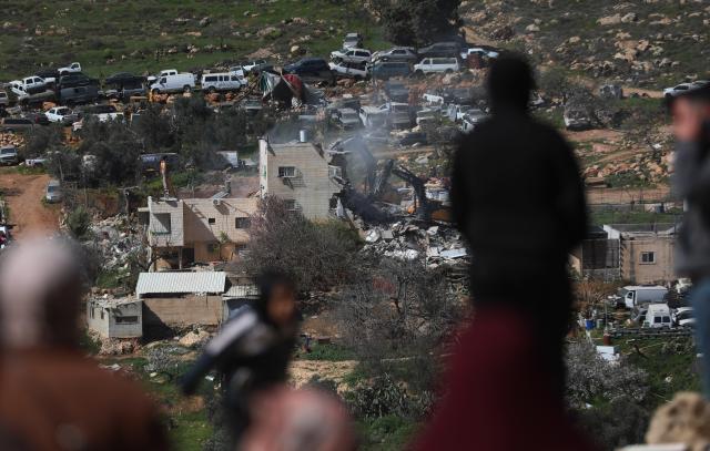 (260218) -- HEBRON, Feb. 18, 2026 (Xinhua) -- Photo shows Israeli excavators demolishing a Palestinian residential building in the southern West Bank city of Hebron on Feb. 18, 2026. (Photo by Mamoun Wazwaz/Xinhua)