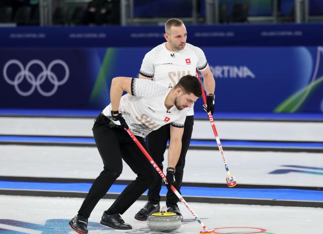 (260218) -- CORTINA D'AMPEZZO, Feb. 18, 2026 (Xinhua) -- Sven Michel and Pablo Lachat-Couchepin of Switzerland compete during the curling men's round robin session 11 match between Switzerland and Norway at the 2026 Milan-Cortina Winter Olympics in Cortina, Italy, Feb. 18, 2026. (Xinhua/Ding Xu)