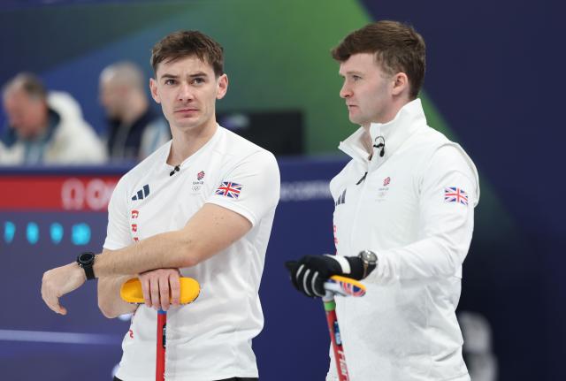 (260218) -- CORTINA D'AMPEZZO, Feb. 18, 2026 (Xinhua) -- Grant Hardie (L) and Bruce Mouat of Britain react during the curling men's round robin session 11 match between Britain and the United States at the 2026 Milan-Cortina Winter Olympics in Cortina, Italy, Feb. 18, 2026. (Xinhua/Ding Xu)