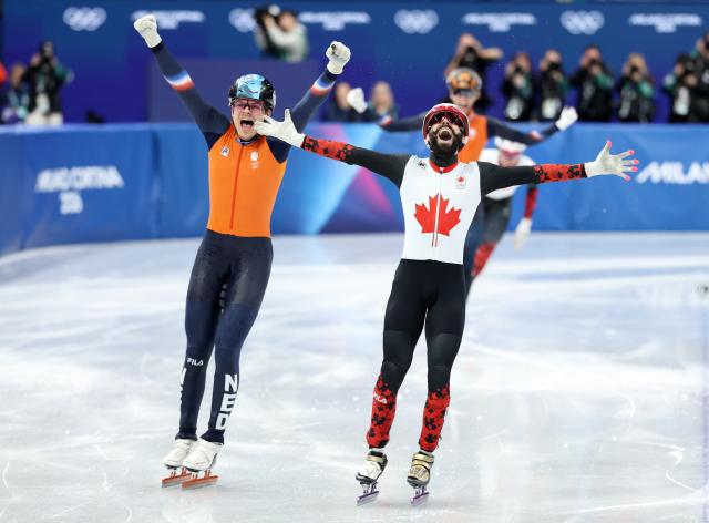 (260218) -- MILAN, Feb. 18, 2026 (Xinhua) -- Steven Dubois (front) of Canada celebrates after the short track speed skating men's 500m final A at the Milan-Cortina 2026 Olympic Winter Games in Milan, Italy, Feb. 18, 2026. (Xinhua/Li Ming)