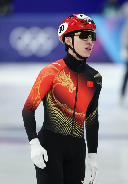 (260218) -- MILAN, Feb. 18, 2026 (Xinhua) -- Lin Xiaojun of China reacts after the short track speed skating men's 500m quarterfinal at the Milan-Cortina 2026 Olympic Winter Games in Milan, Italy, Feb. 18, 2026. (Xinhua/Li Ming)