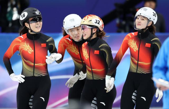 (260218) -- MILAN, Feb. 18, 2026 (Xinhua) -- Gong Li, Zhang Chutong, Yang Jingru and Wang Xinran (L to R) of China react after the short track speed skating women's 3000m relay final B at the Milan-Cortina 2026 Olympic Winter Games in Milan, Italy, Feb. 18, 2026. (Xinhua/Li Ming)