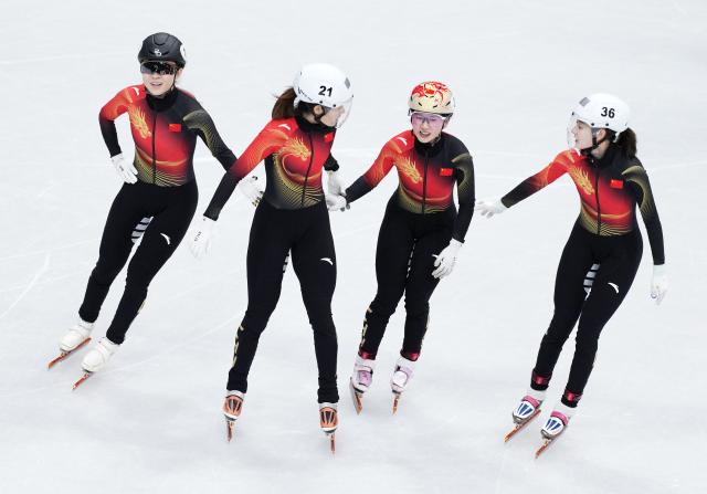 (260219) -- MILAN, Feb. 19, 2026 (Xinhua) -- Gong Li, Zhang Chutong, Yang Jingru and Wang Xinran (from L to R) of China celebrate after the short track speed skating women's 3000m relay final B at the Milan-Cortina 2026 Olympic Winter Games in Milan, Italy, Feb. 18, 2026. (Xinhua/Xue Yuge)