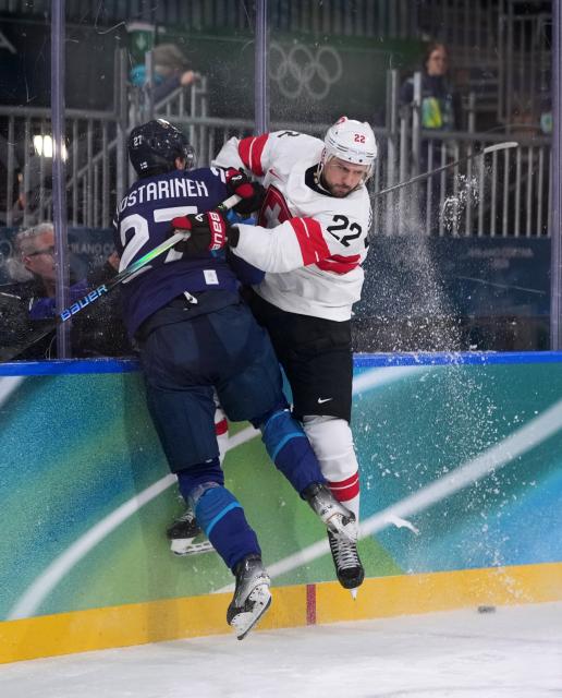 (260219) -- MILAN, Feb. 19, 2026 (Xinhua) -- Eetu Luostarinen (L) of Finland fights for the puck against Nino Niederreiter of Switzerland during the ice hockey men's play-offs quarterfinal between Finland and Switzerland at the Milan-Cortina 2026 Olympic Winter Games in Milan, Italy, Feb. 18, 2026. (Xinhua/Tao Xiyi)