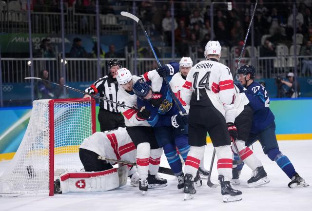 (260219) -- MILAN, Feb. 19, 2026 (Xinhua) -- Players of both teams compete during the ice hockey men's play-offs quarterfinal between Finland and Switzerland at the Milan-Cortina 2026 Olympic Winter Games in Milan, Italy, Feb. 18, 2026. (Xinhua/Tao Xiyi)