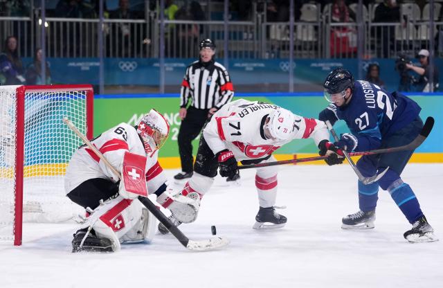 (260219) -- MILAN, Feb. 19, 2026 (Xinhua) -- Switzerland's Leonardo Genoni (L) makes a save during the ice hockey men's play-offs quarterfinal between Finland and Switzerland at the Milan-Cortina 2026 Olympic Winter Games in Milan, Italy, Feb. 18, 2026. (Xinhua/Tao Xiyi)