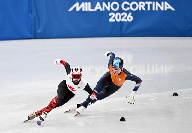 (260219) -- MILAN, Feb. 19, 2026 (Xinhua) -- Steven Dubois (L) of Canada and Melle van't Wout of the Netherlands compete during the short track speed skating men's 500m final A at the Milan-Cortina 2026 Olympic Winter Games in Milan, Italy, Feb. 18, 2026. (Xinhua/Cheng Min)