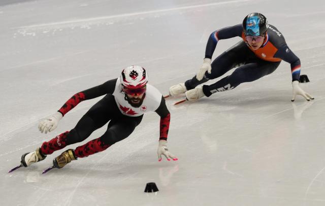 (260219) -- MILAN, Feb. 19, 2026 (Xinhua) -- Steven Dubois (L) of Canada and Melle van't Wout of the Netherlands compete during the short track speed skating men's 500m final A at the Milan-Cortina 2026 Olympic Winter Games in Milan, Italy, Feb. 18, 2026. (Xinhua/Lai Xiangdong)