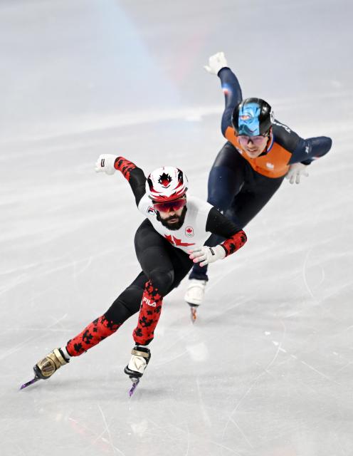 (260219) -- MILAN, Feb. 19, 2026 (Xinhua) -- Steven Dubois (L) of Canada and Melle van't Wout of the Netherlands compete during the short track speed skating men's 500m final A at the Milan-Cortina 2026 Olympic Winter Games in Milan, Italy, Feb. 18, 2026. (Xinhua/Cheng Min)