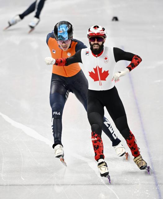 (260219) -- MILAN, Feb. 19, 2026 (Xinhua) -- Steven Dubois (R) of Canada crosses the finish line during the short track speed skating men's 500m final A at the Milan-Cortina 2026 Olympic Winter Games in Milan, Italy, Feb. 18, 2026. (Xinhua/Cheng Min)