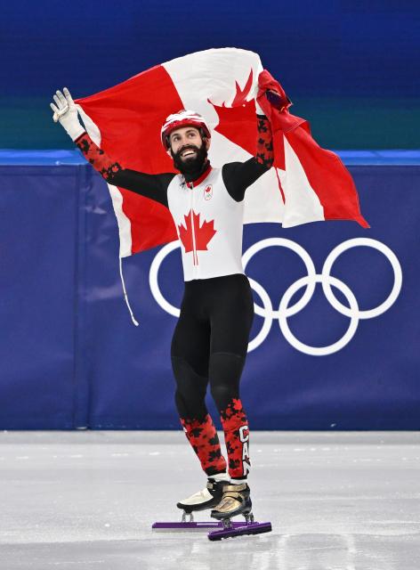 (260219) -- MILAN, Feb. 19, 2026 (Xinhua) -- Steven Dubois of Canada celebrates after winning the short track speed skating men's 500m final A at the Milan-Cortina 2026 Olympic Winter Games in Milan, Italy, Feb. 18, 2026. (Xinhua/Cheng Min)