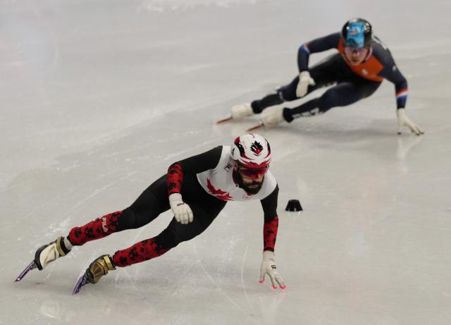 (260219) -- MILAN, Feb. 19, 2026 (Xinhua) -- Steven Dubois (L) of Canada and Melle van't Wout of the Netherlands compete during the short track speed skating men's 500m final A at the Milan-Cortina 2026 Olympic Winter Games in Milan, Italy, Feb. 18, 2026. (Xinhua/Lai Xiangdong)