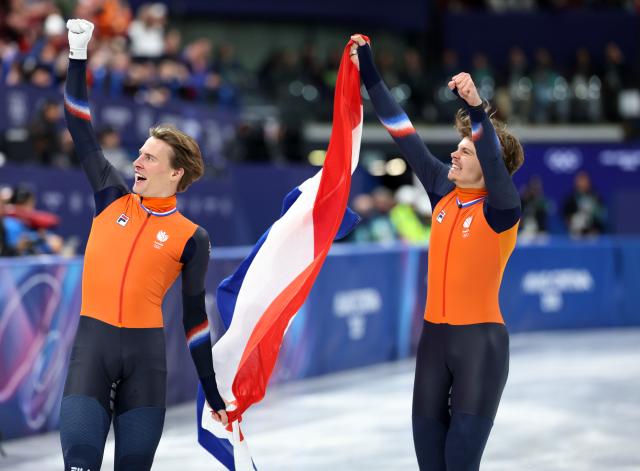 (260219) -- MILAN, Feb. 19, 2026 (Xinhua) -- Melle van't Wout (R) and Jens van't Wout of the Netherlands celebrate after the short track speed skating men's 500m final A at the Milan-Cortina 2026 Olympic Winter Games in Milan, Italy, Feb. 18, 2026. (Xinhua/Li Ming)