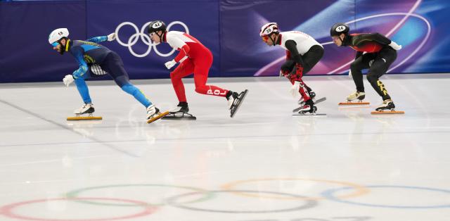(260219) -- MILAN, Feb. 19, 2026 (Xinhua) -- Liu Shaoang (1st R) of China, Maxime Laoun (2nd R) of Canada, Felix Pigeon (2nd L) of Poland and Denis Nikisha of Kazakhstan compete during the short track speed skating men's 500m final B at the Milan-Cortina 2026 Olympic Winter Games in Milan, Italy, Feb. 18, 2026. (Xinhua/Lai Xiangdong)