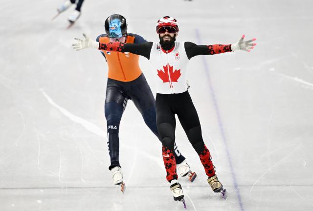 (260219) -- MILAN, Feb. 19, 2026 (Xinhua) -- Steven Dubois (R) of Canada crosses the finish line during the short track speed skating men's 500m final A at the Milan-Cortina 2026 Olympic Winter Games in Milan, Italy, Feb. 18, 2026. (Xinhua/Cheng Min)