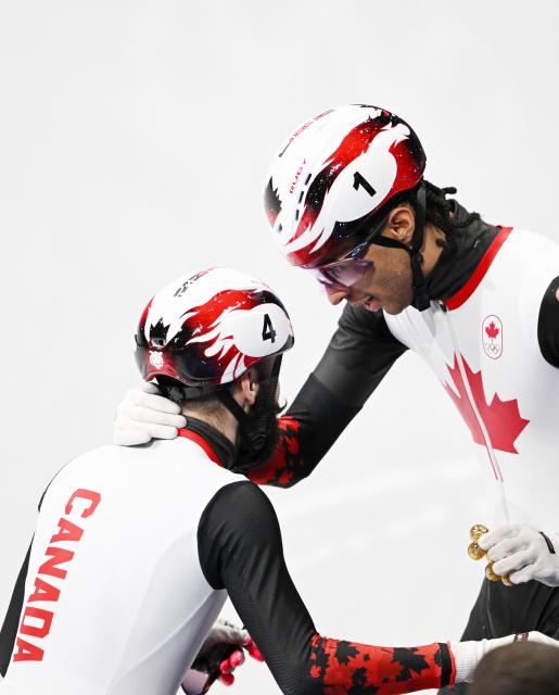 (260219) -- MILAN, Feb. 19, 2026 (Xinhua) -- Steven Dubois (L) of Canada celebrates with teammate William Dandjinou after winning the short track speed skating men's 500m final A at the Milan-Cortina 2026 Olympic Winter Games in Milan, Italy, Feb. 18, 2026. (Xinhua/Cheng Min)