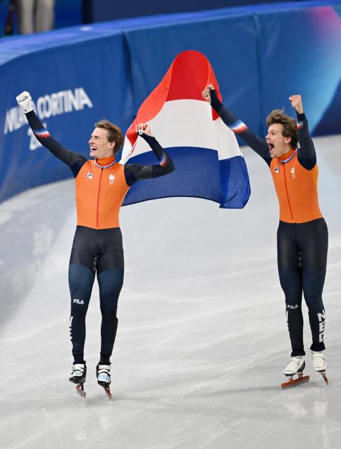 (260219) -- MILAN, Feb. 19, 2026 (Xinhua) -- Melle van't Wout (R) and Jens van't Wout of the Netherlands celebrate after the short track speed skating men's 500m final A at the Milan-Cortina 2026 Olympic Winter Games in Milan, Italy, Feb. 18, 2026. (Xinhua/Cheng Min)