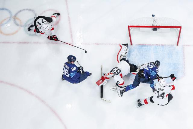 (260219) -- MILAN, Feb. 19, 2026 (Xinhua) -- Players of both teams compete during the ice hockey men's play-offs quarterfinal between Finland and Switzerland at the Milan-Cortina 2026 Olympic Winter Games in Milan, Italy, Feb. 18, 2026. (Xinhua/Sun Fei)