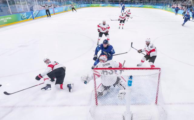 (260219) -- MILAN, Feb. 19, 2026 (Xinhua) -- Players of both teams compete during the ice hockey men's play-offs quarterfinal between Finland and Switzerland at the Milan-Cortina 2026 Olympic Winter Games in Milan, Italy, Feb. 18, 2026. (Xinhua/Sun Fei)