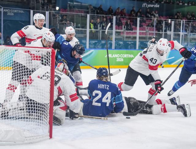 (260219) -- MILAN, Feb. 19, 2026 (Xinhua) -- Players of both teams compete during the ice hockey men's play-offs quarterfinal between Finland and Switzerland at the Milan-Cortina 2026 Olympic Winter Games in Milan, Italy, Feb. 18, 2026. (Xinhua/Sun Fei)