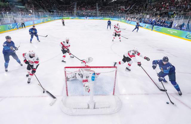 (260219) -- MILAN, Feb. 19, 2026 (Xinhua) -- Players of both teams compete during the ice hockey men's play-offs quarterfinal between Finland and Switzerland at the Milan-Cortina 2026 Olympic Winter Games in Milan, Italy, Feb. 18, 2026. (Xinhua/Sun Fei)