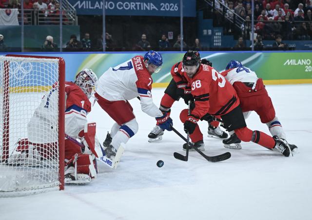 (260219) -- MILAN, Feb. 19, 2026 (Xinhua) -- Brandon Hagel (2nd R) of Canada vies with David Spacek (2nd L) of the Czech Republic during the ice hockey men's play-offs quarterfinals match between Canada and the Czech Republic at the Milan-Cortina 2026 Olympic Winter Games in Milan, Italy, Feb. 18, 2026. (Xinhua/Zhang Haofu)
