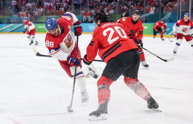 (260219) -- MILAN, Feb. 19, 2026 (Xinhua) -- David Pastrnak (L) of the Czech Republic shoots during the ice hockey men's play-offs quarterfinals match between Canada and the Czech Republic at the Milan-Cortina 2026 Olympic Winter Games in Milan, Italy, Feb. 18, 2026. (Xinhua/Wang Kaiyan)